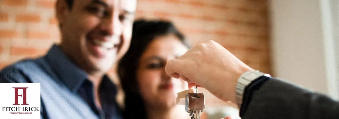 A person is handing over a key to another person. at Coit Village Apartments, Florence, SC
